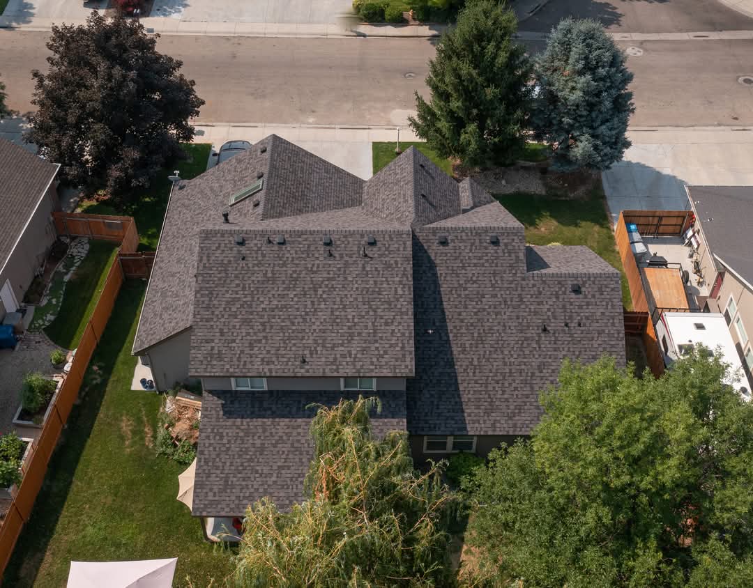 Before and after of a finished shingle roof on a suburban home