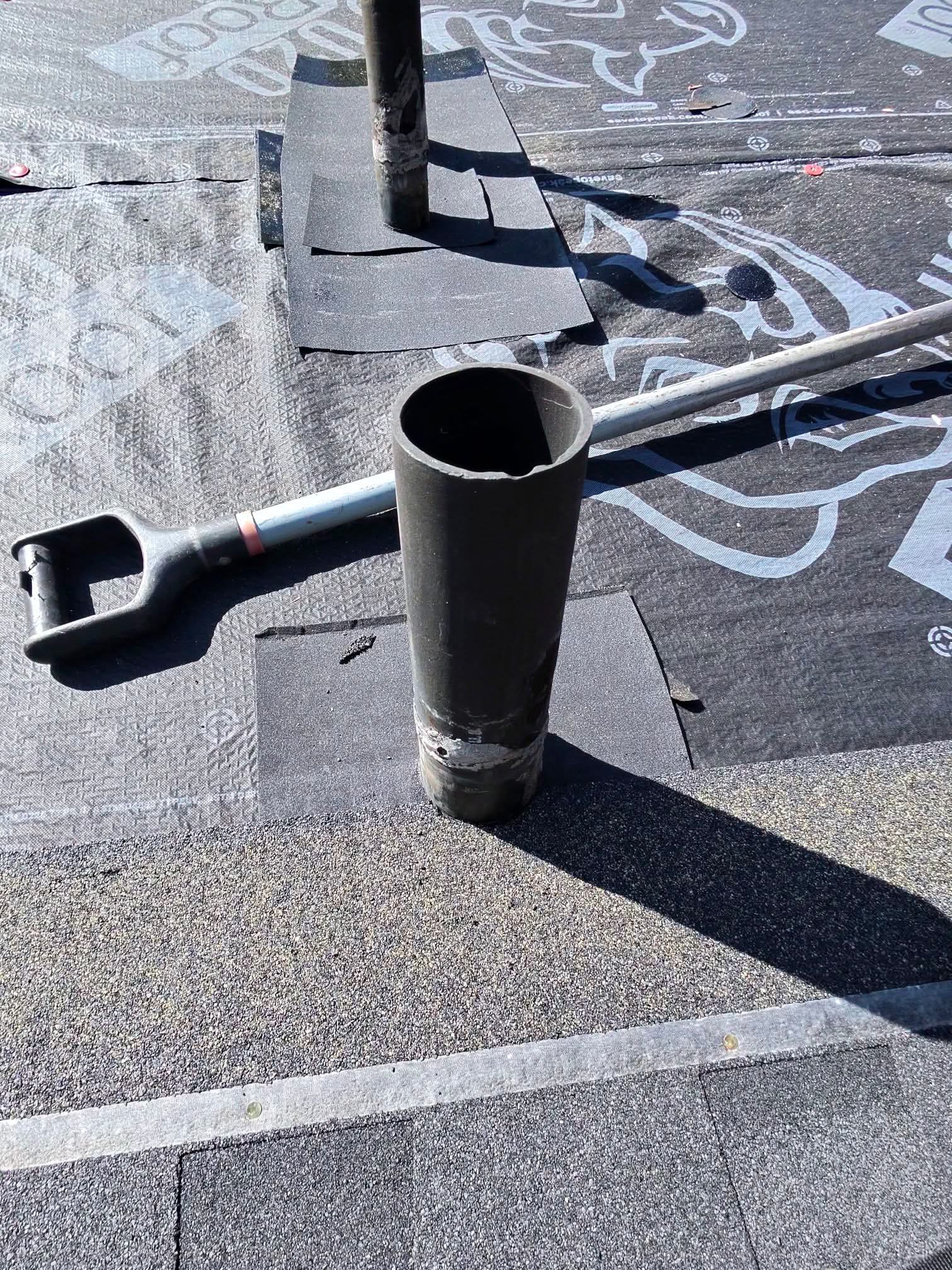 Ice and water shield membrane cut and fitted around a pipe flashing penetration on a roof deck