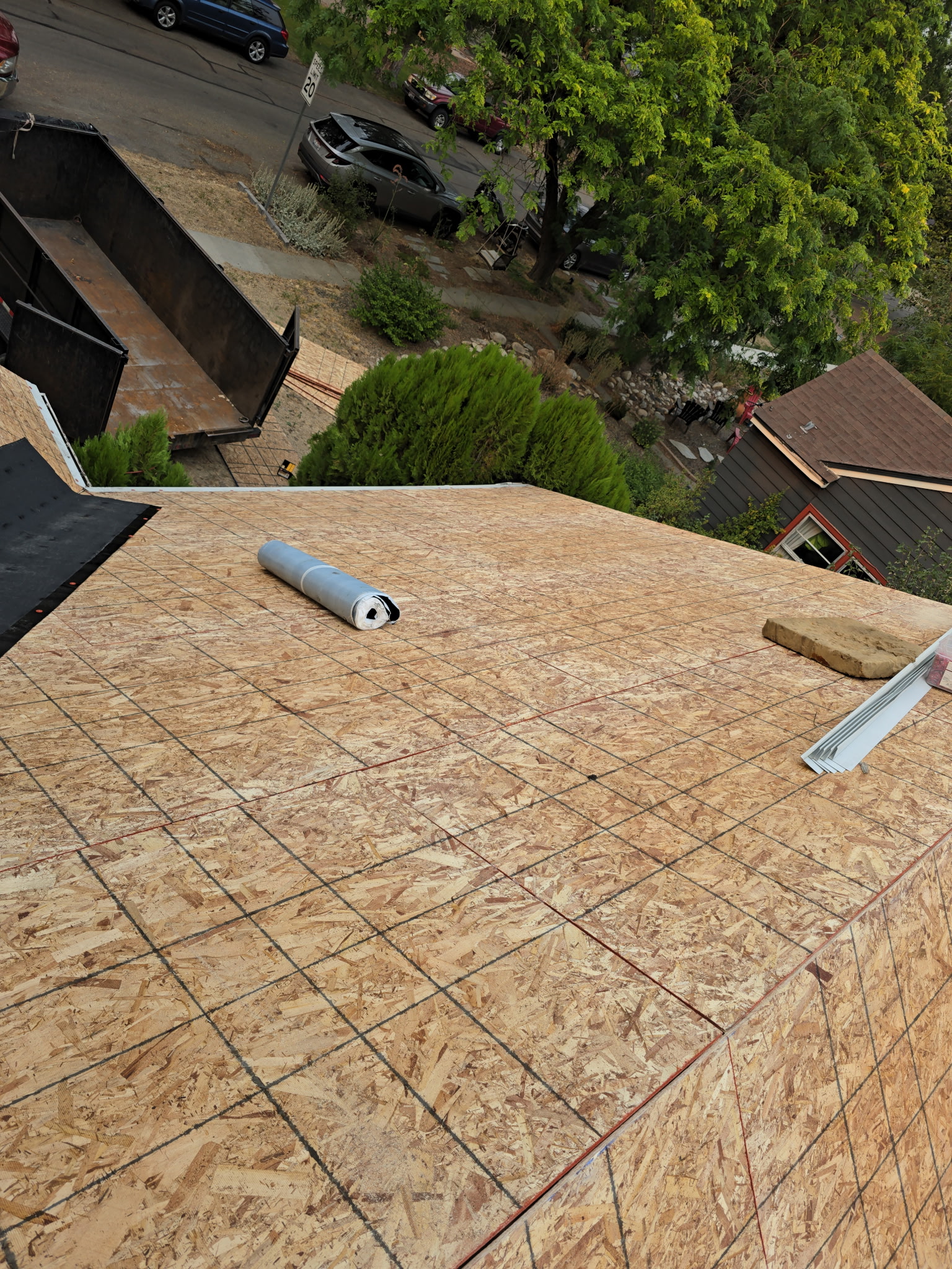 Roofer working on a roof covered in synthetic underlayment
