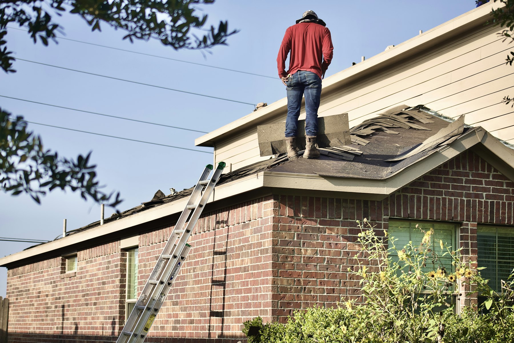 Asphalt shingle roof being repaired on a residential home